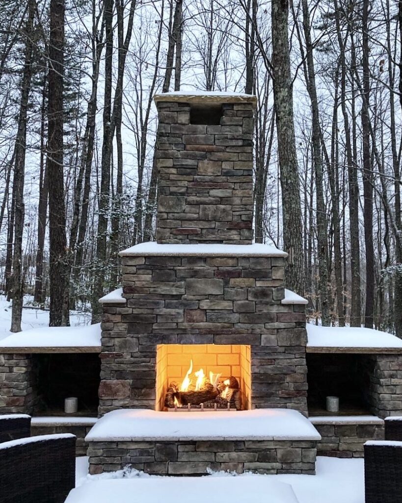 outdoor fireplace in the snow installed by Lapis Patios