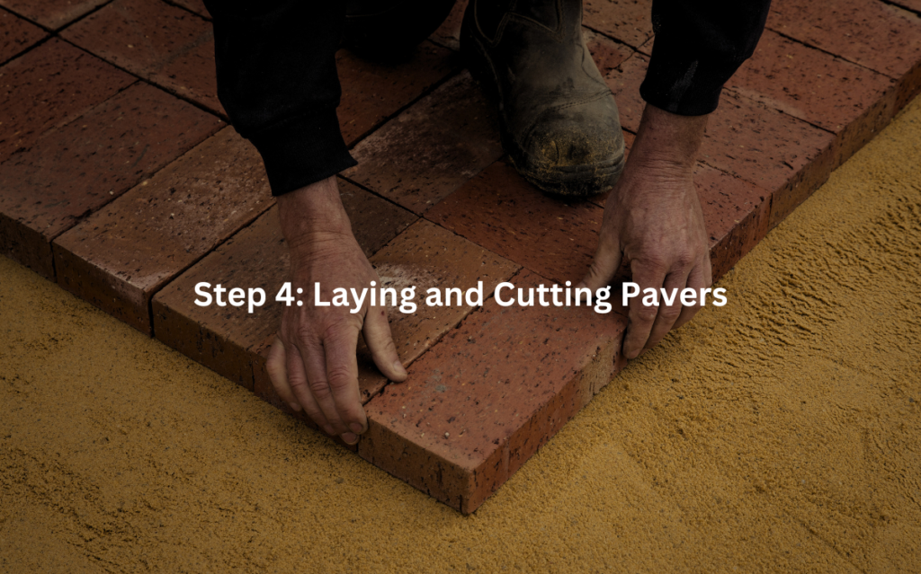 Hands laying interlocking paving stones on a prepared surface.